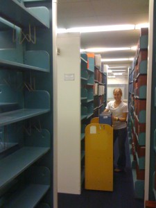 Student worker aka Kelsi moving rows of books
